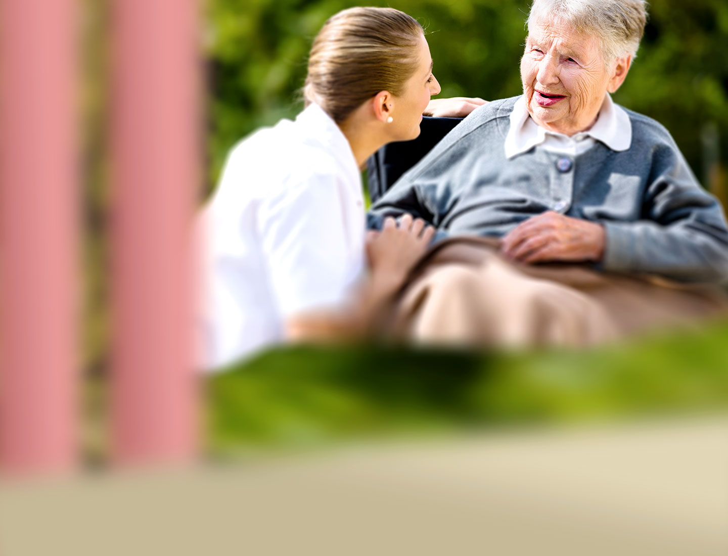 Seniorin mit Pflegeperson im Park